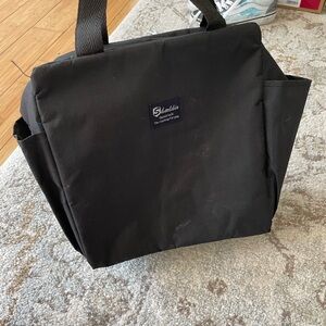 Black tote bag with insulation on inside and two pockets on outside